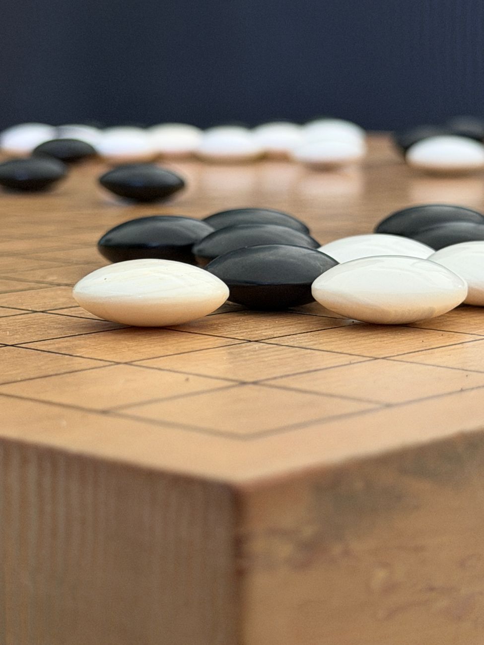 close up of go game board with stones